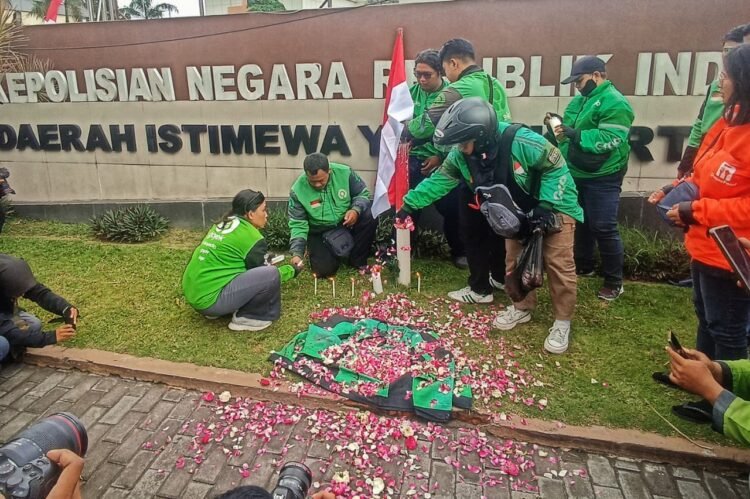 Pengemudi ojek online (ojol) menggelar aksi solidaritas di Mapolda DIY pada Jumat (29/8/2025).