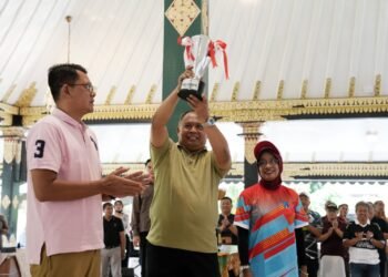 Bupati Sleman, Harda Kiswaya (tengah), mengangkat piala bergilir Peparda di Pendapa Parasamya Kabupaten Sleman, Sabtu (20/9/2025). (Dok. Pemkab Sleman)
