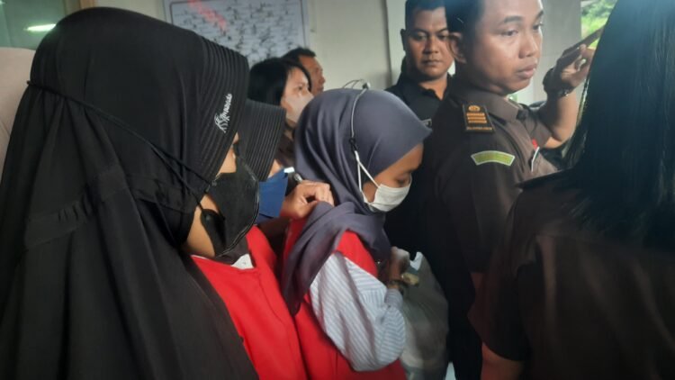 Tersangka kekerasan kepada balita di Daycare Little Aresha saat dibawa ke mobil tahanan.
