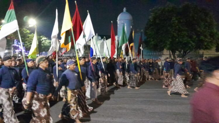Ribuan orang tampak khidmat mengikuti ritual Tapa Bisu atau Hajad Kawula Dalem Lampah Budaya Mubeng Beteng saat melintas di Pojok Benteng Timur, Kota Yogyakarta, Rabu (17/6/2026).