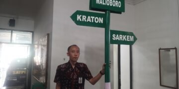 Kepala Seksi Pengendalian Operasional Satpol PP Kota Yogyakarta, Yudho Bangun Pamungkas, menunjukkan plang portabel milik oknum fotografer di Jalan Malioboro yang disita dan diamankan ke Kantor Satpol PP Kota Yogyakarta, Selasa (4/8/2026).